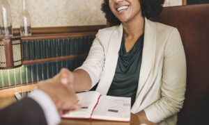 Woman shaking hands with business partner